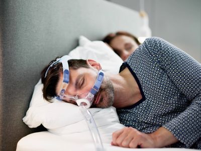 A person wearing anti snore device